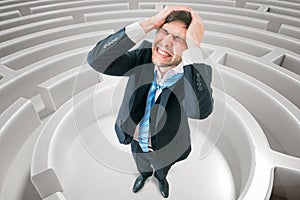 Young man is confused and lost in maze. 3D rendered illustration of maze