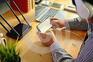 Young man Connecting router wifi On smartphone  for Internet and social media