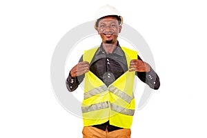 Young man construction engineer showing his safety vest smiling