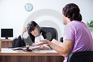 Young man consulting with judge on litigation issue