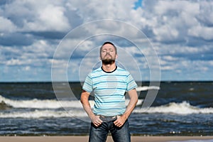 Young man contemplating on a beach