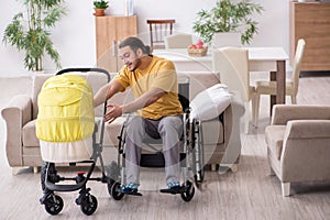 Young man contractor in wheel-chair looking after newborn