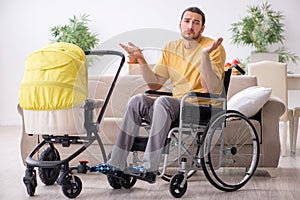 Young man contractor in wheel-chair looking after newborn