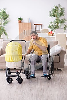 Young man contractor in wheel-chair looking after newborn