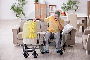 Young man contractor in wheel-chair looking after newborn