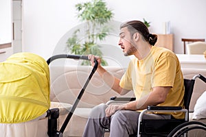 Young man contractor in wheel-chair looking after newborn