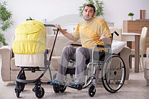 Young man contractor in wheel-chair looking after newborn