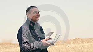 A young man controls a drone with remote control.