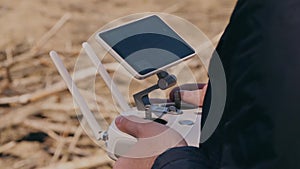 A young man controls a drone with remote control.