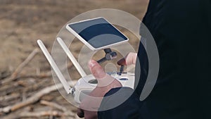 A young man controls a drone with remote control.