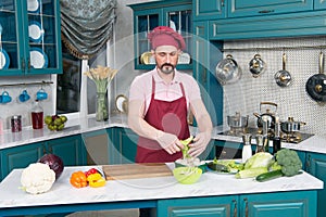 A Young Man Cooking in the kitchen. Healthy Food - Vegetable Salad. Vegan Diet. Vegan Dieting Concept. Healthy Lifestyle.