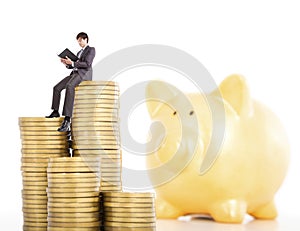 Young man counting coin in piggy bank