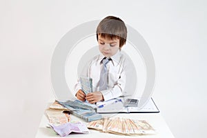 Young man, counting money and taking notes