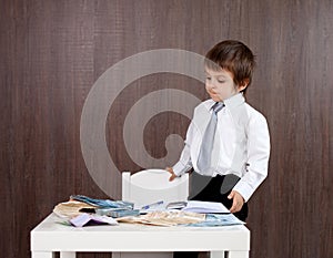 Young man, counting money and taking notes