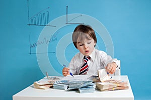Young man, counting money and taking notes