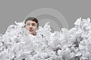 Young Man Covered In Crumpled Papers