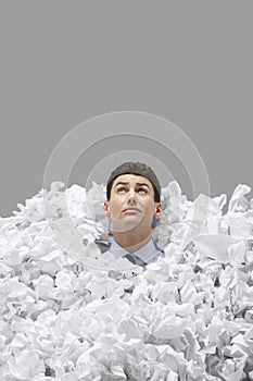 Young Man Covered In Crumpled Papers