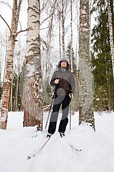 Young man cross-country skiing in the forest