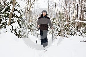 Young man cross-country skiing in the forest