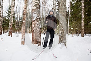 Young man cross-country skiing in the forest