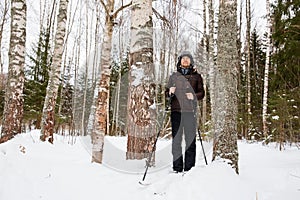 Young man cross-country skiing in the forest