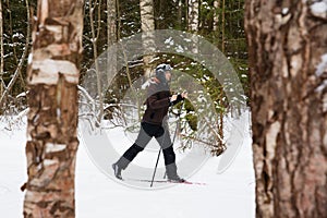 Young man cross-country skiing in the forest