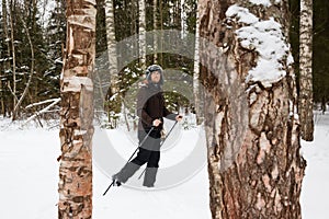 Young man cross-country skiing in the forest