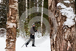 Young man cross-country skiing in the forest