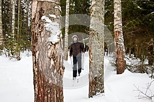 Young man cross-country skiing in the forest