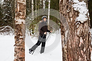 Young man cross-country skiing in the forest