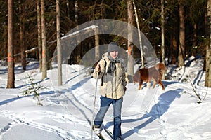 Young man cross-country skiing through the forest