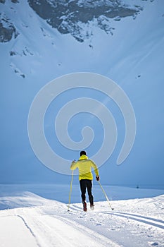 Young man cross-country skiing on a winter day