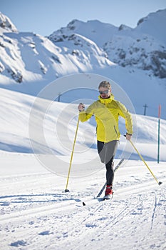 Young man cross-country skiing on a winter day