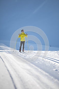 Young man cross-country skiing on a winter day