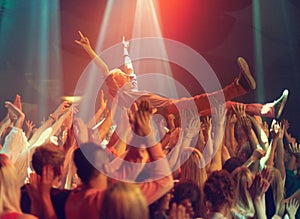 A young man crowd surfing to his favorite band. This concert was created for the sole purpose of this photo shoot