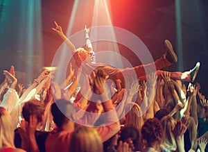 A young man crowd surfing to his favorite band. This concert was created for the sole purpose of this photo shoot