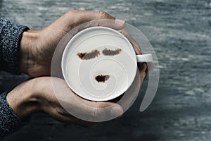 Young man with a cup of cappuccino