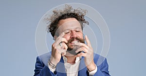 Young man with curly hair posing in studio