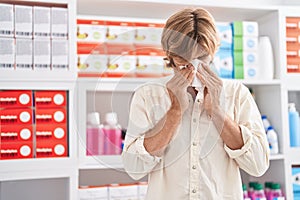 Young man customer using napkin at pharmacy