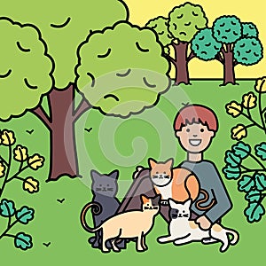 Young man with cute cats mascots on the park
