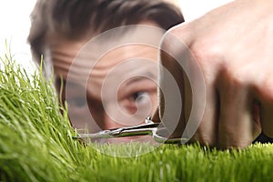 Young man cuts English lawn