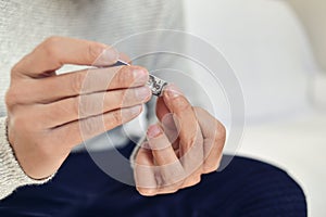 Young man cutting his fingernails