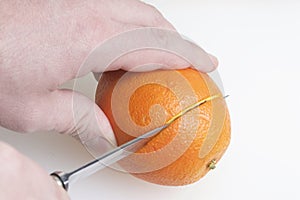 Young man cutting oranges.