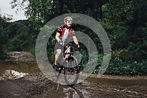 The young man cycling on mountain bike ride Cross-country