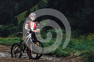 The young man cycling on mountain bike ride Cross-country