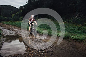 The young man cycling on mountain bike ride Cross-country