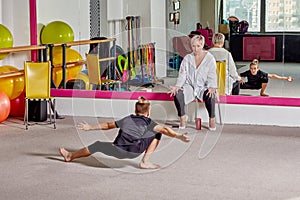 A young man dances at a ballet school. Sports lifestyle and body flexibility.