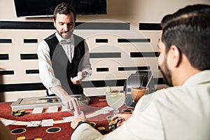 Young man dealing cards in a casino