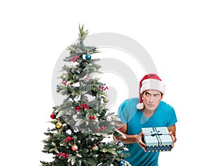 Young man decorating christmas tree isolated on white