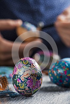 Young man decorating homemade easter eggs